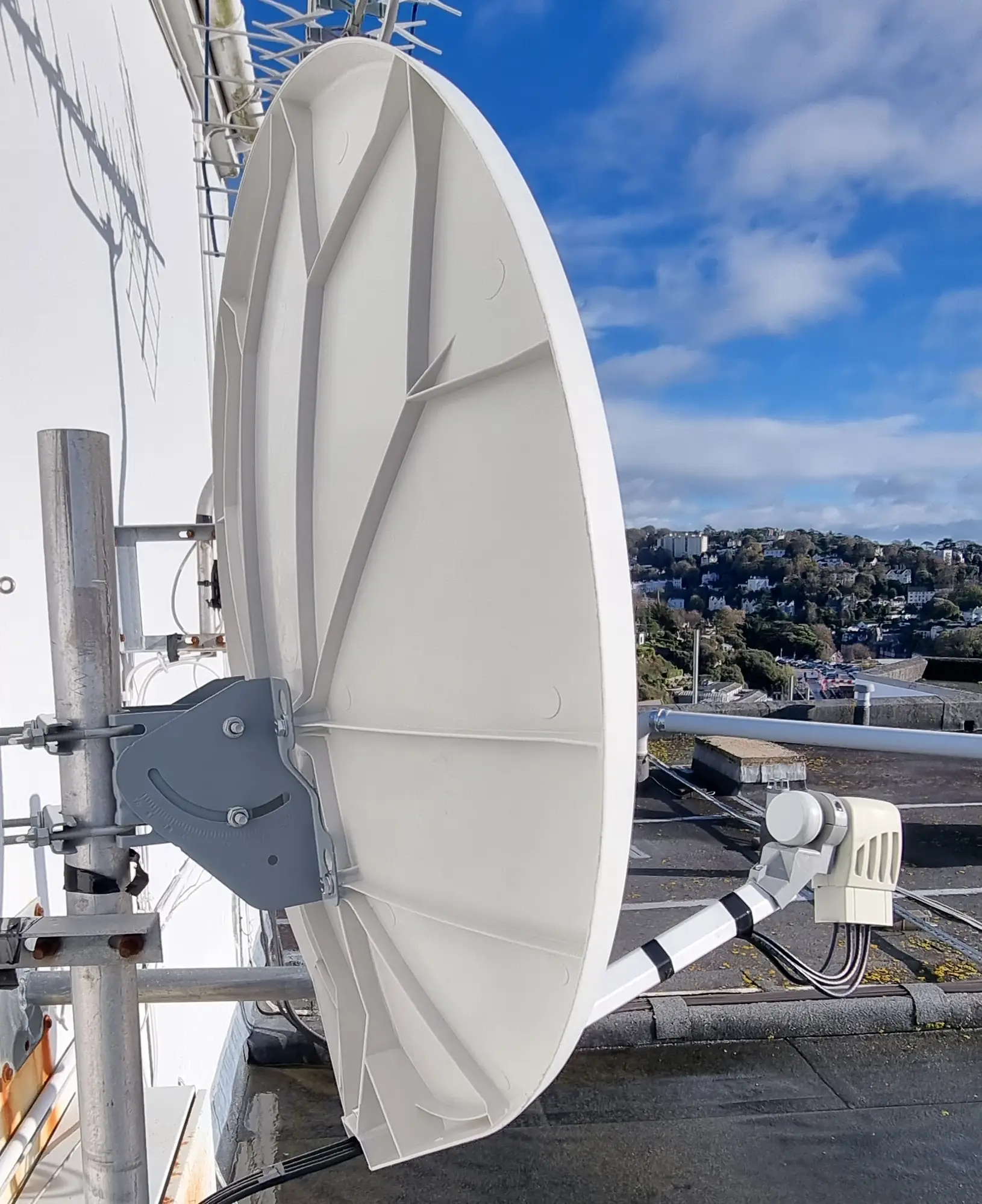 satellite dish repair brixham Installer adjusting satellite dish to improve signal quality on a residential property in Brixham