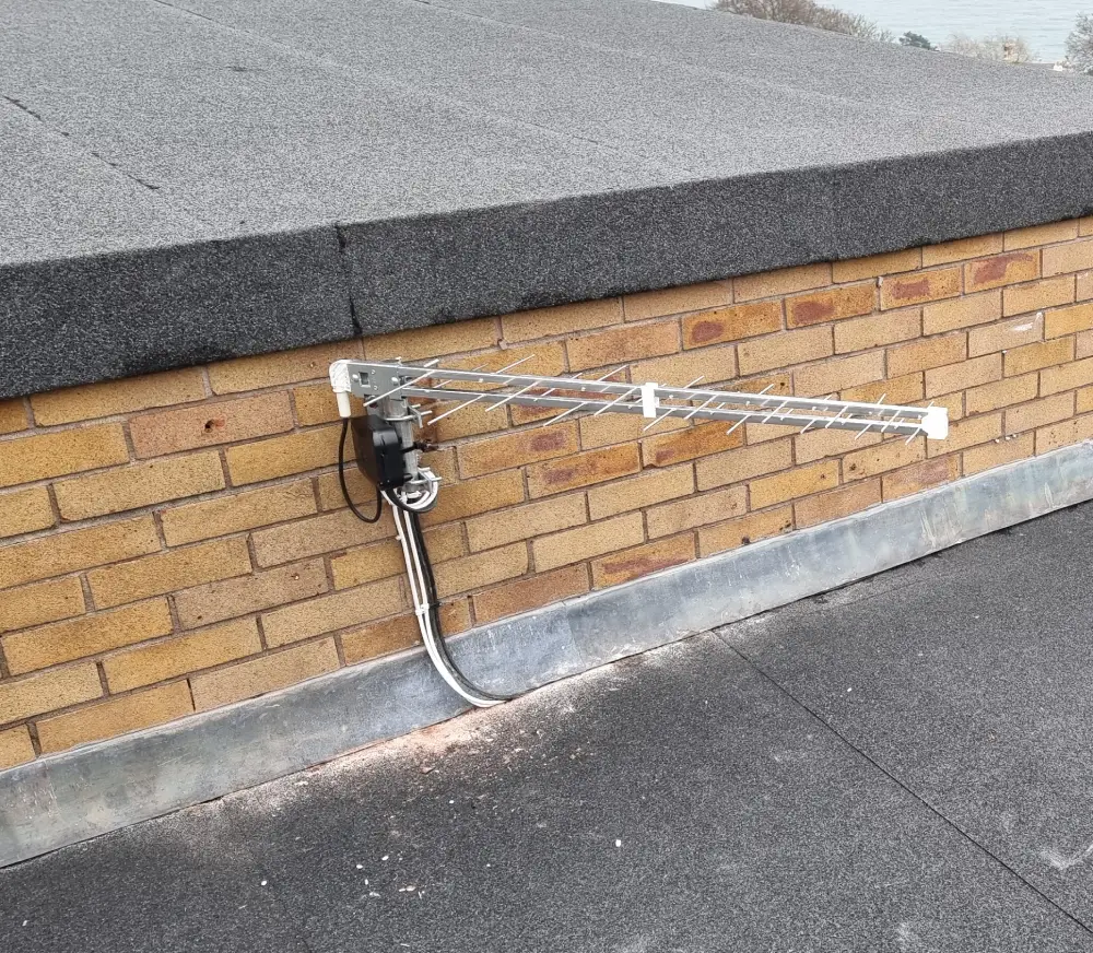 tv aerial flat roof Aerial installation specialist running cables for a TV antenna in a residential home in Torbay