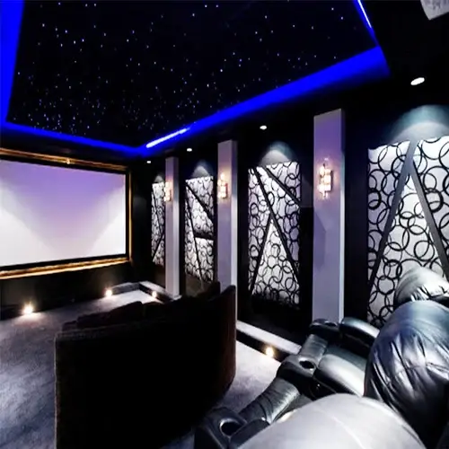 home theatre setup devon Setting up a premium home theatre system with sleek speakers and projector in a South Devon living room