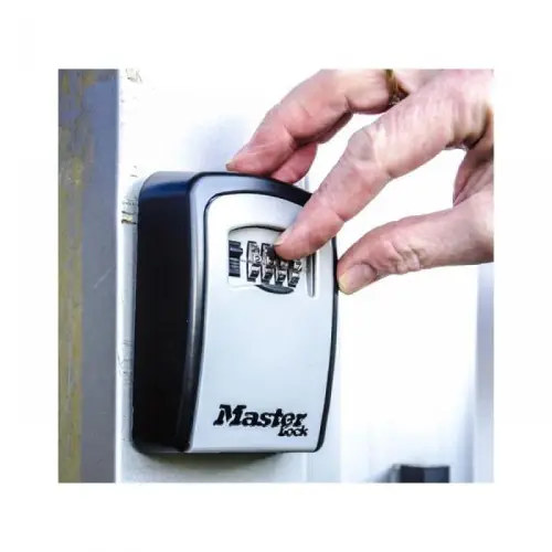 keysafe installation Torbay Digital technician securely installing a keysafe on a property wall, ensuring quick access and safety for clients