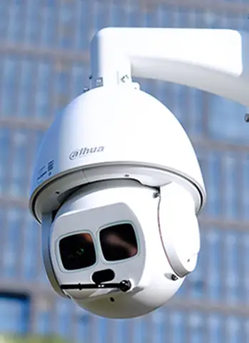 ptz camera Close-up of a PTZ (Pan-Tilt-Zoom) CCTV camera mounted on a farm building, offering 360-degree surveillance coverage